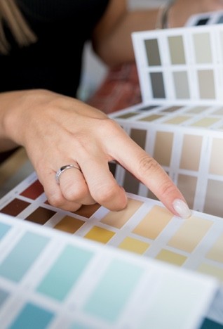 Woman looking at paint samples | Flemington Department Store