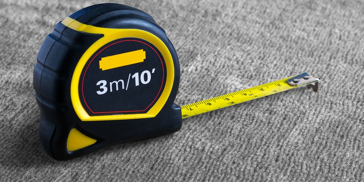 Black yellow Measuring Tape on gray carpet | Flemington Department Store